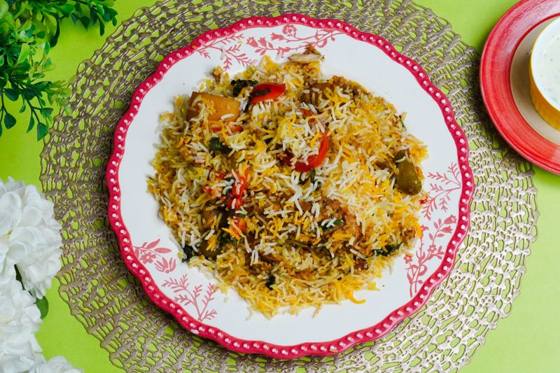 Homemade chicken biryani served on a decorated plate