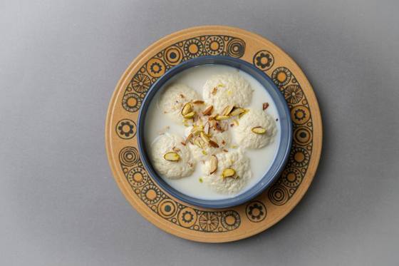 Ras malai in creamy milk topped with pistachios and almonds