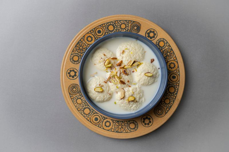 Ras malai in creamy milk topped with pistachios and almonds