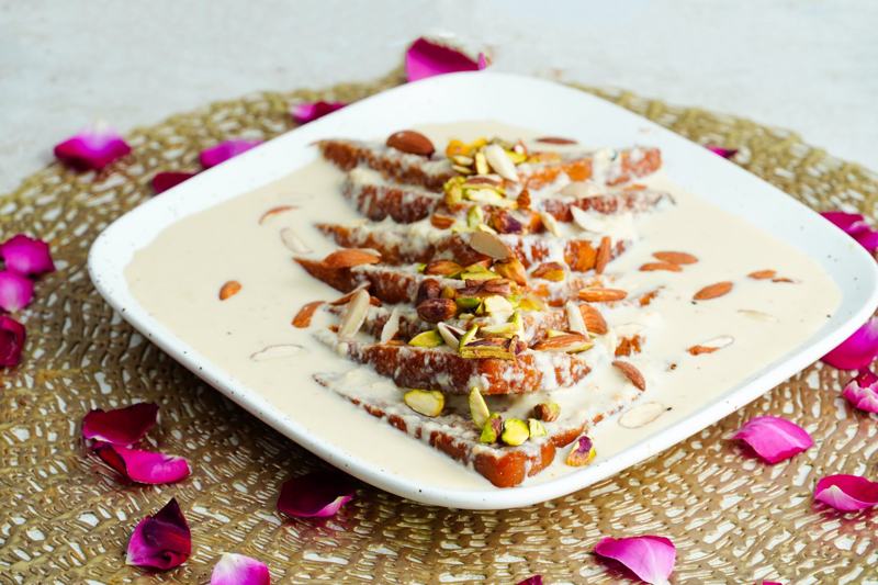 Shahi tukra with creamy rabri, almonds, pistachios and rose petals